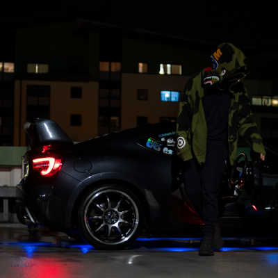 A man getting out of his car at night.