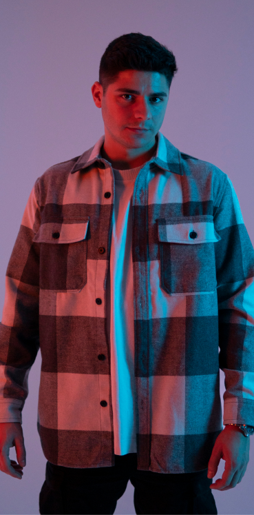 A portrait of one of my male models in a studio with purple and orange lighting.